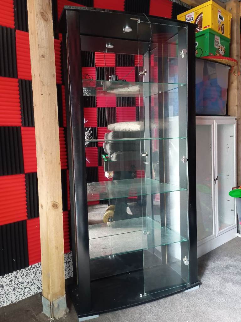 Glass shelved black, mirror backed display cabinet 
