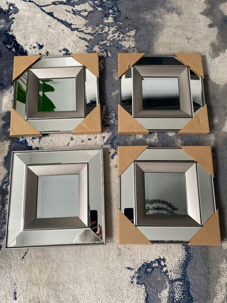New in box set of 4 silver mirrored wall art