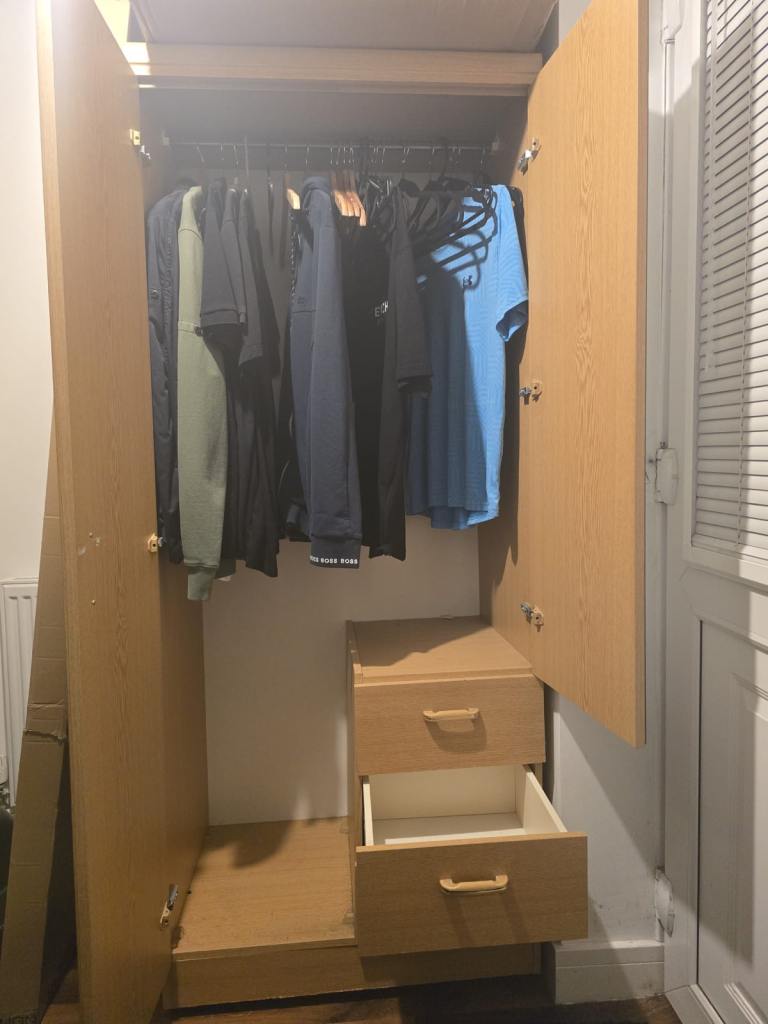 cabinet with two doors and two drawers, with a mirror on the door