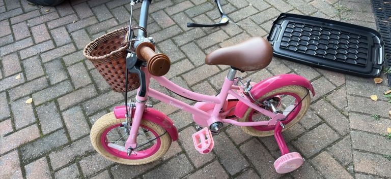 Pink bike with training wheels 