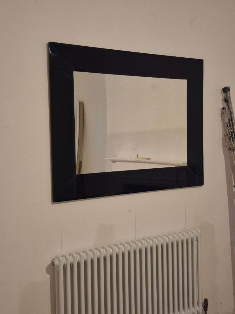 Large glass mirror with black glass border 