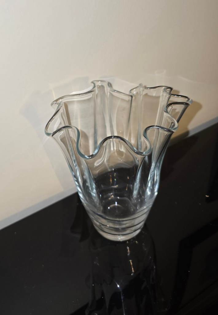 Clear glass vase with wavy rim