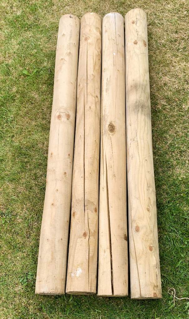 Four wooden machine poles - good condition