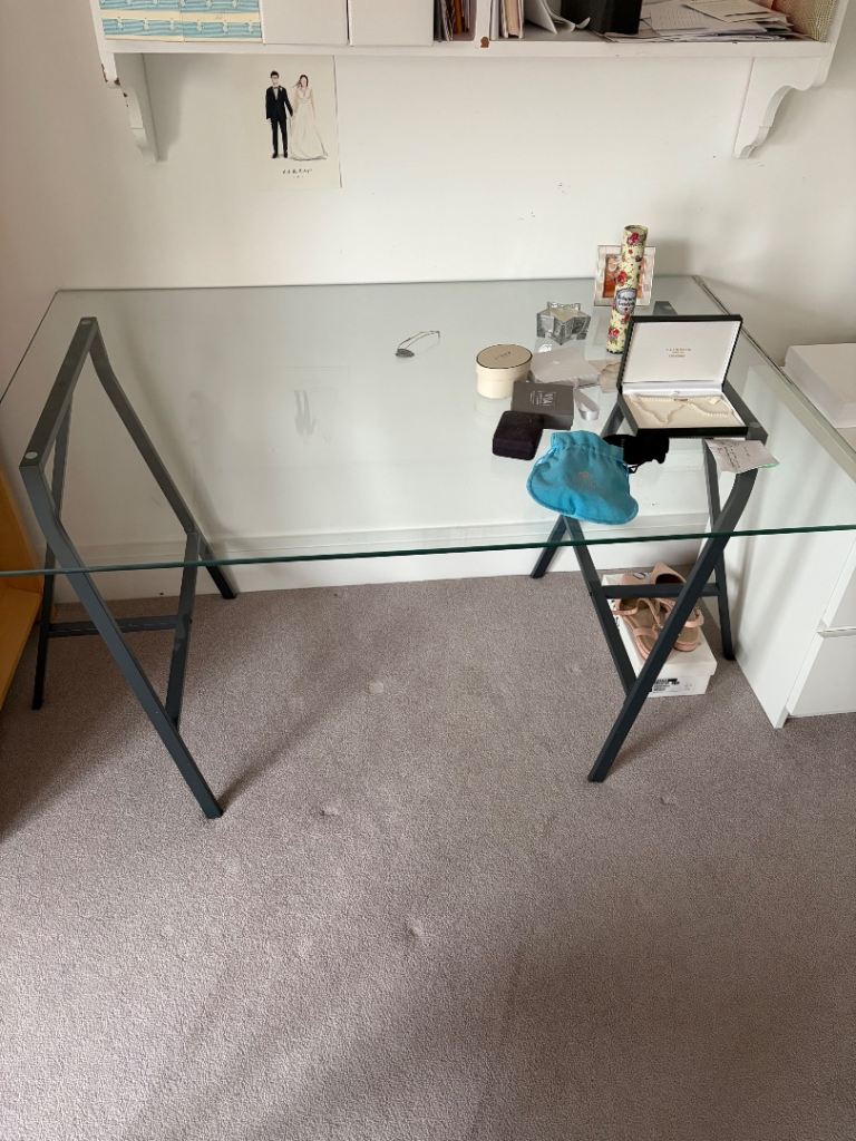 Glass desk with metal supports
