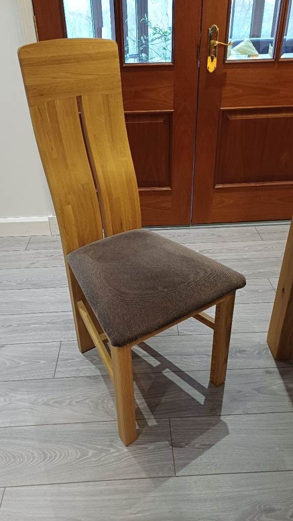 Two solid oak high-back dining chairs