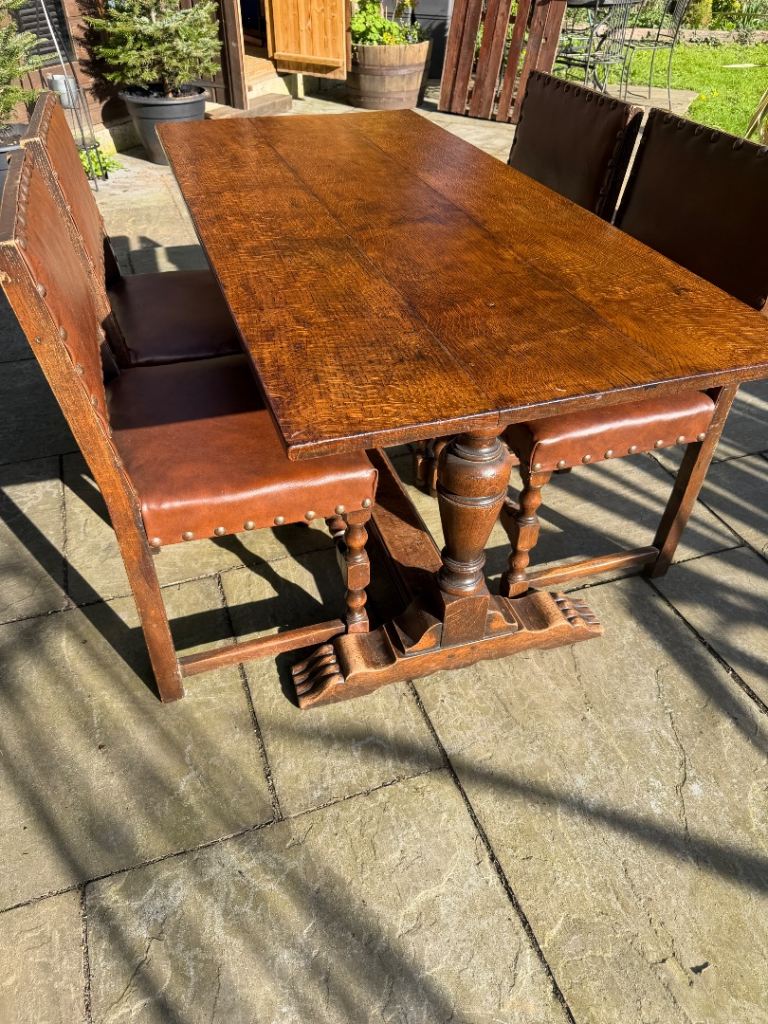 1800’s wooden table and four studded chairs