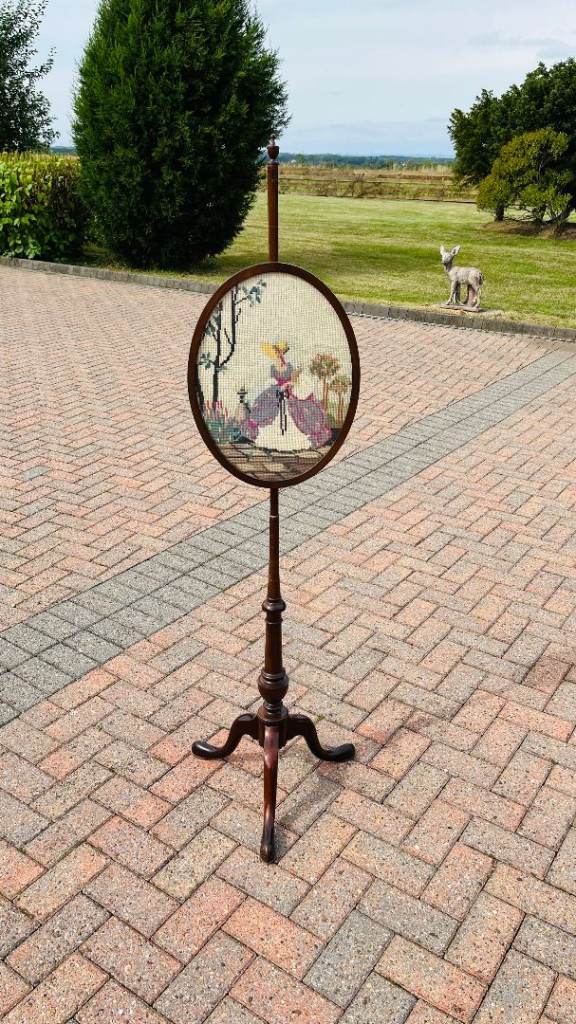 A MAHOGANY TAPESTRY POLE SCREEN.