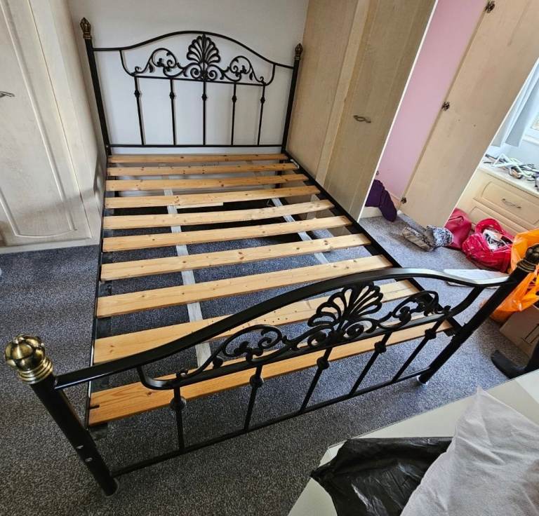 Black metal four poster bedframe for double bed