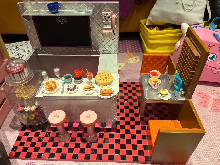 OUR GENERATION DOLL CAFE comes with a doll for free