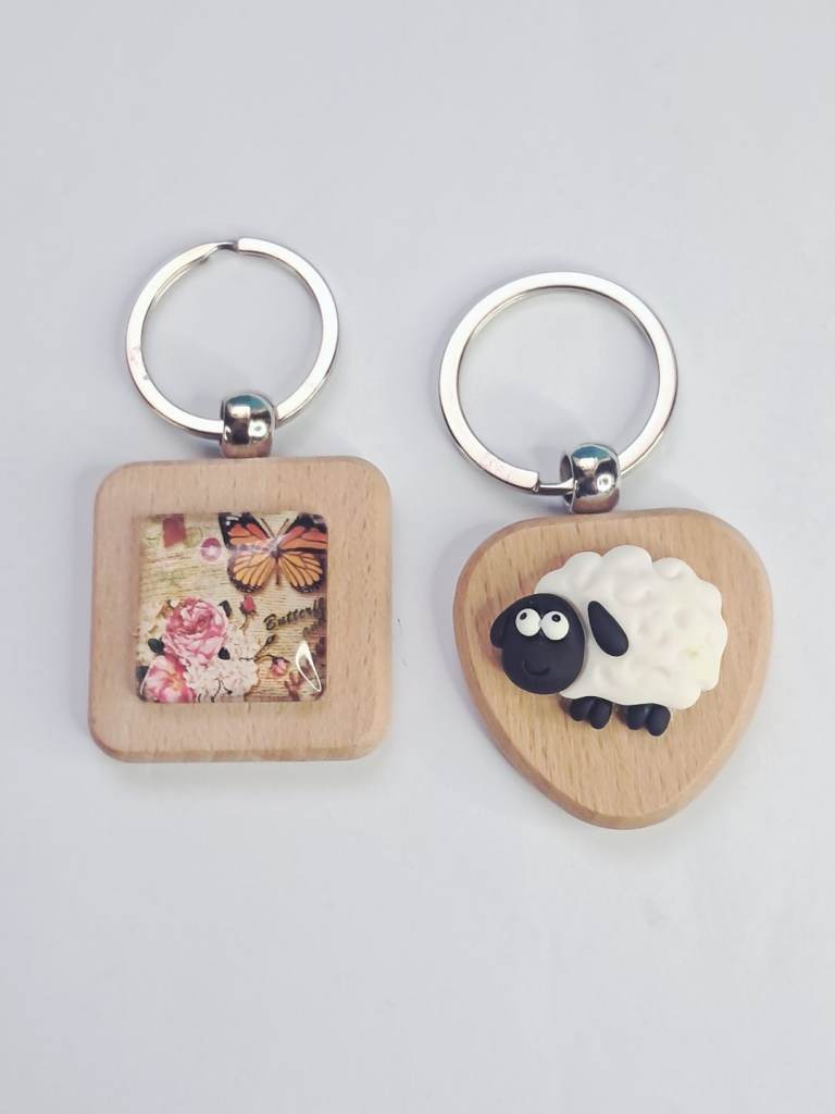 Handmade wooden keychains sheep and  butterfly design,produced by a Scottish Welsh brand.