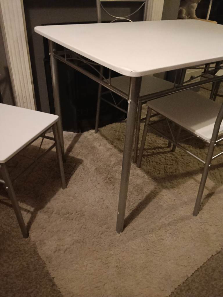 White dining table and four chairs feel free to contact me 