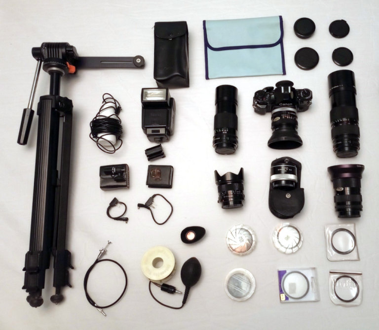 Canon A1 35mm film SLR camera with 6 lenses, flash and a number of accessories.