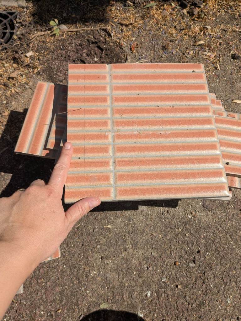 Free porcelain tile offcuts in terracotta for crafts or mosaics