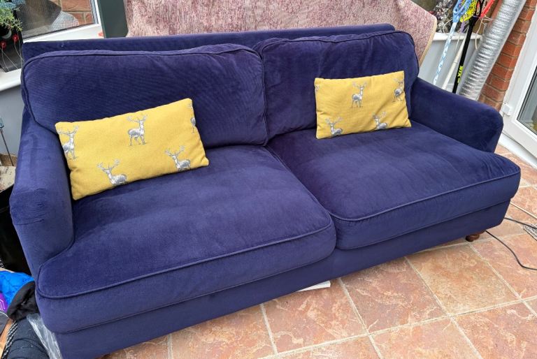 Large navy sofa with cushions