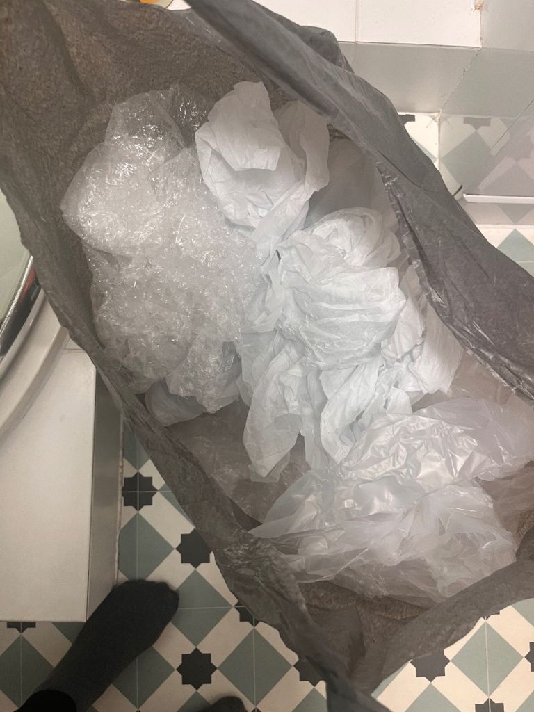 Black bag of packing materials.