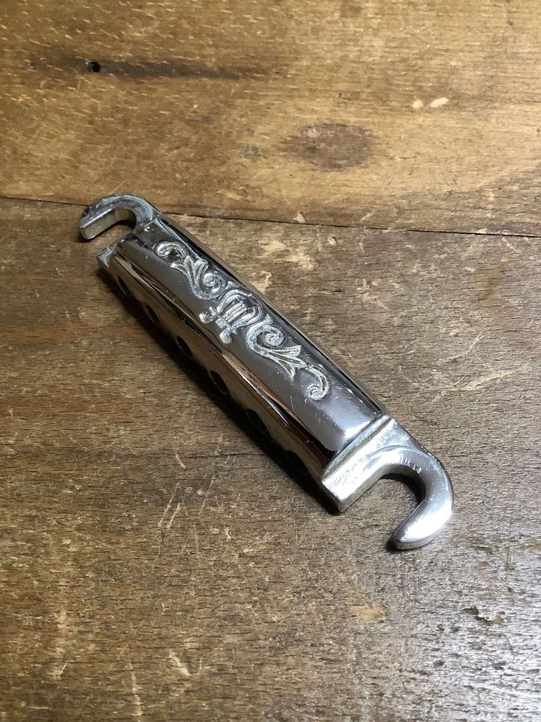 Original 1970s Scroll and Harp motif embossed Yamaha SG Tailpiece 