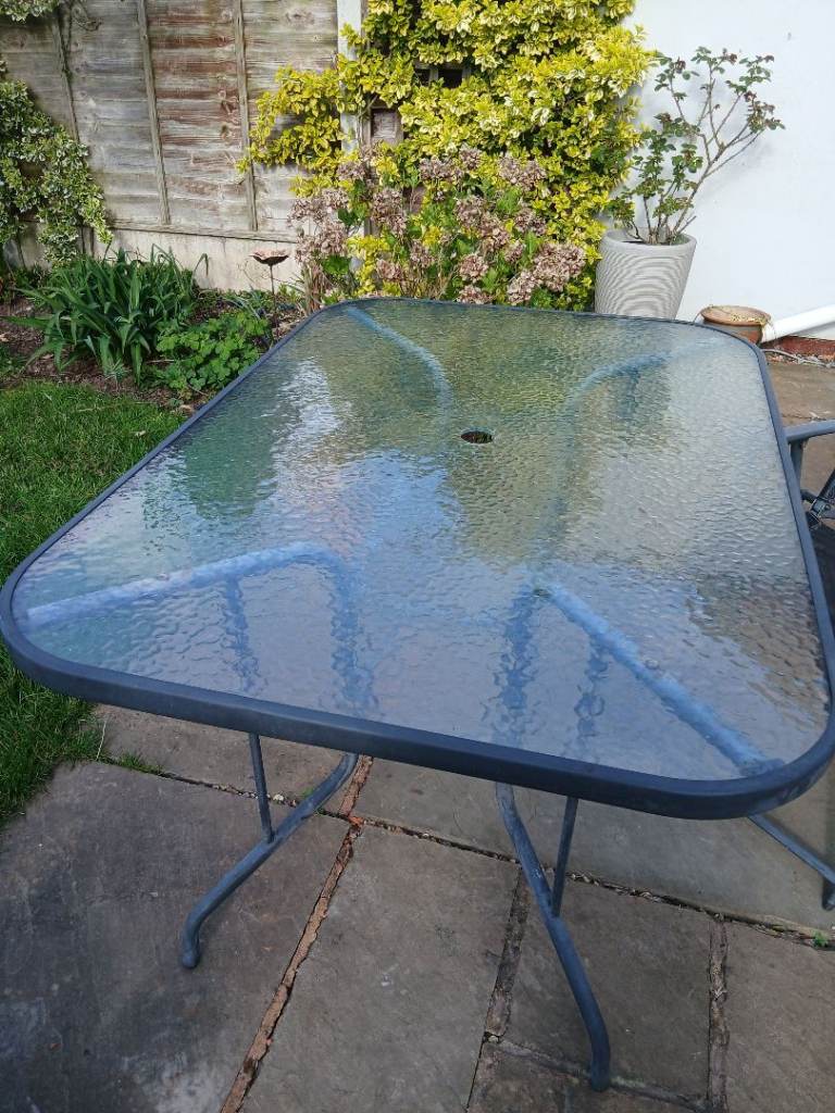 Glass topped table and 4 fold up chairs