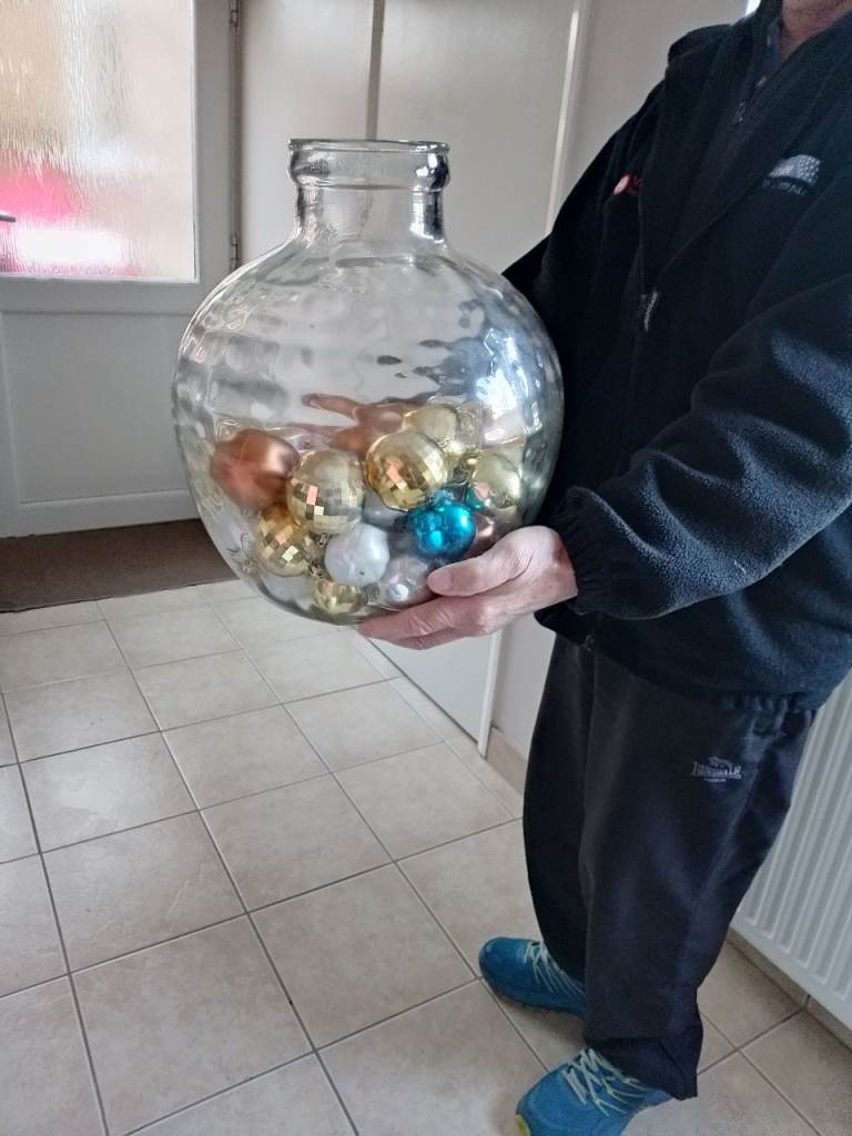 Giant glass bottle with assorted Christmas baubles 