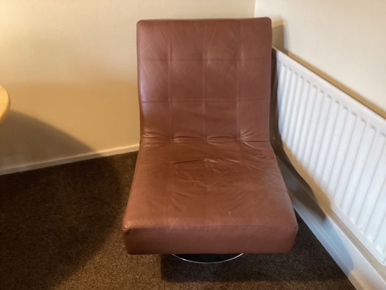 Leather swivel chair with leather footstool 