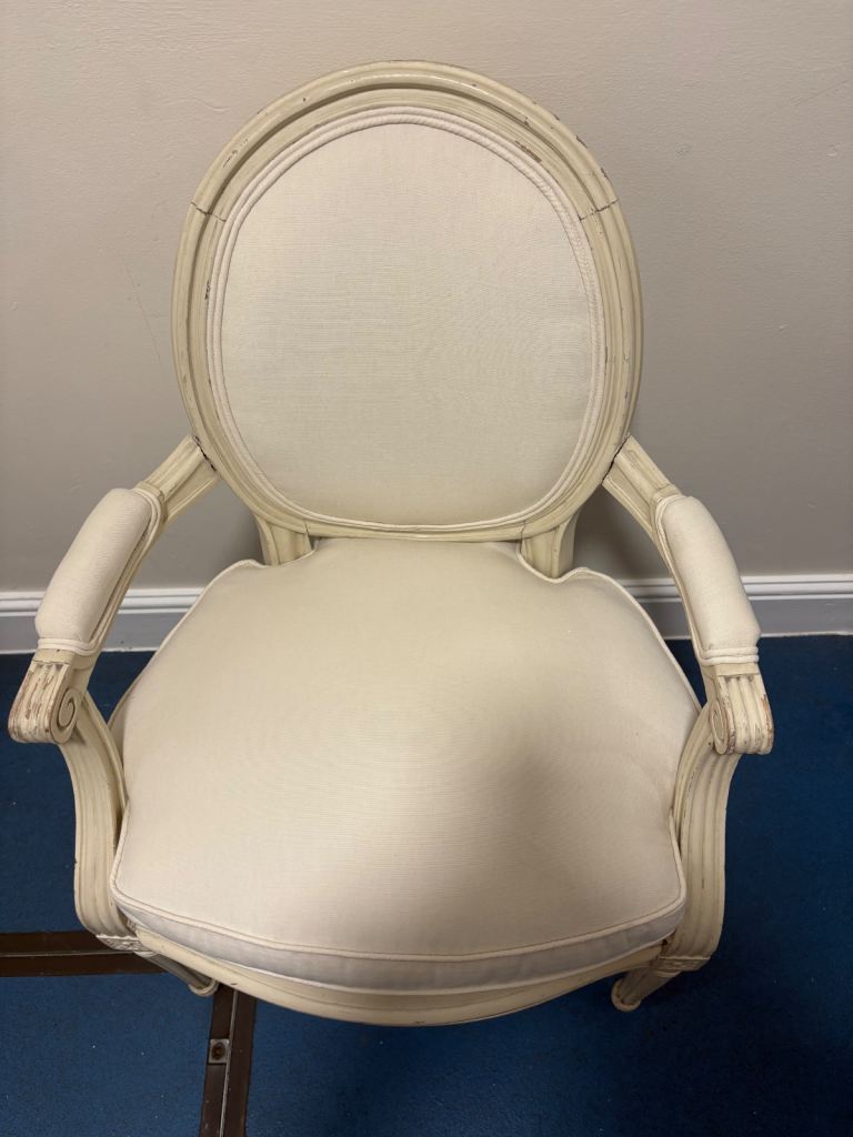 Louis XVI-style Medallion Armchair with a distressed white finish and upholstered cushions