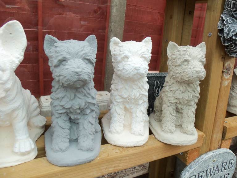 Stone concrete garden statue ornament of a Yorkshire terrier.