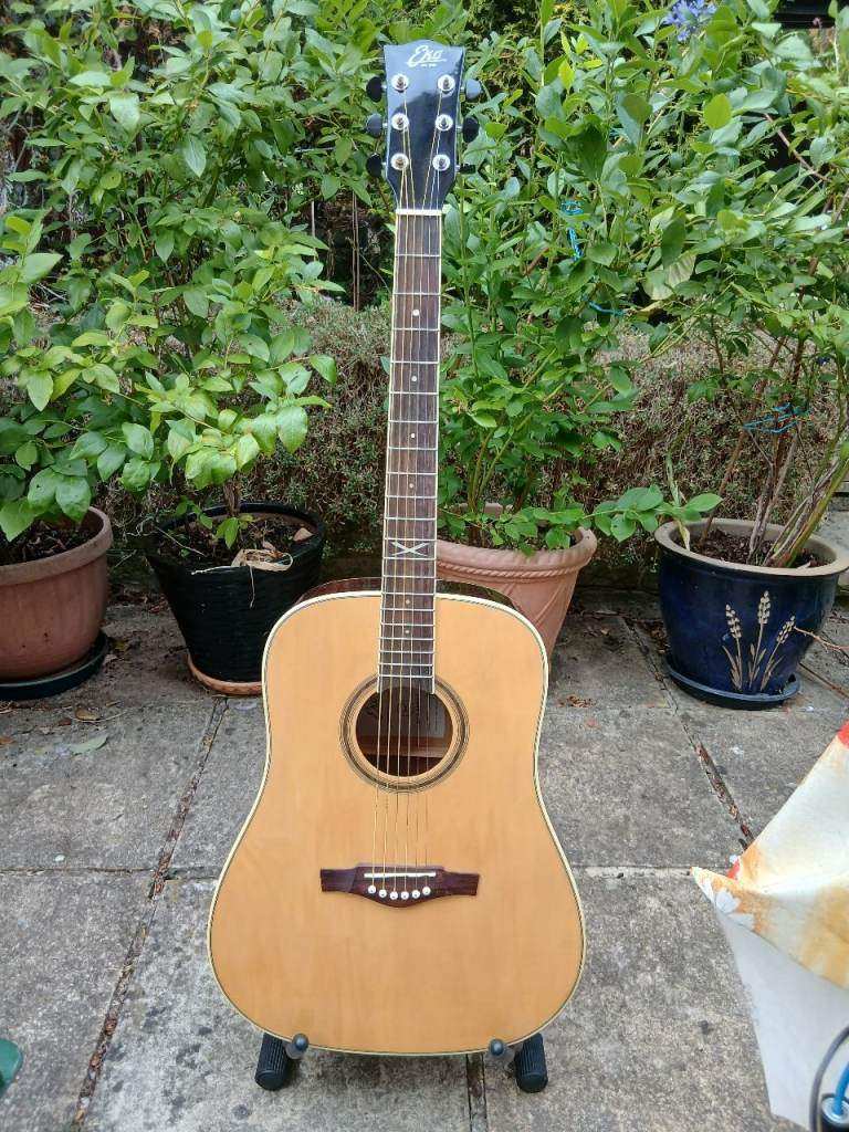 Acoustic guitar by Eko NXT D series, natural wood finish, comes with a carry case, great condition
