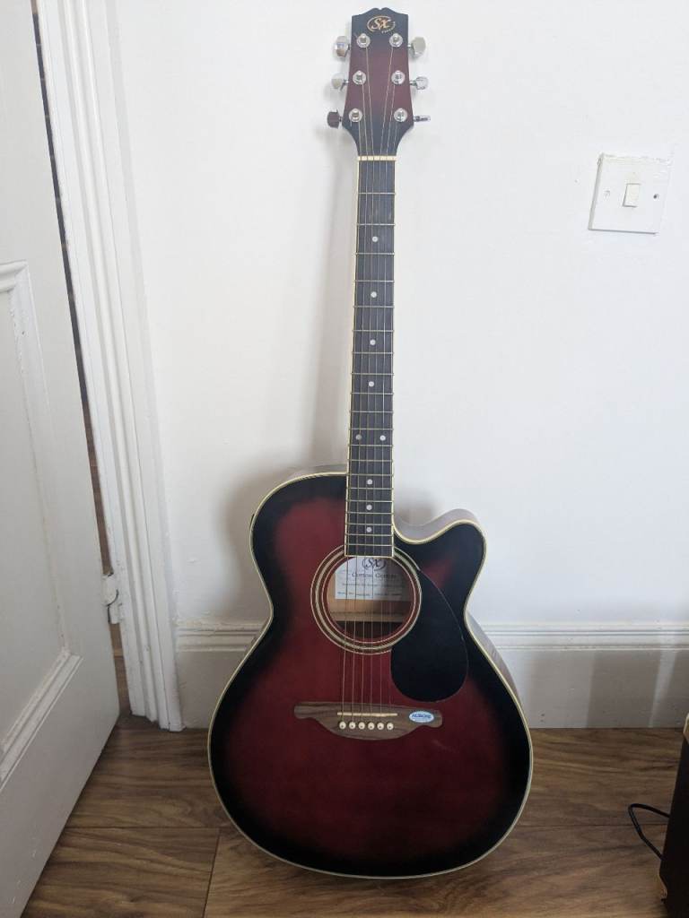 Sx electric acoustic guitar with its speaker 