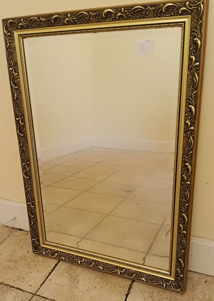 Mirror gilded with raised floral motifs with bevelled edging 87 x 61cms