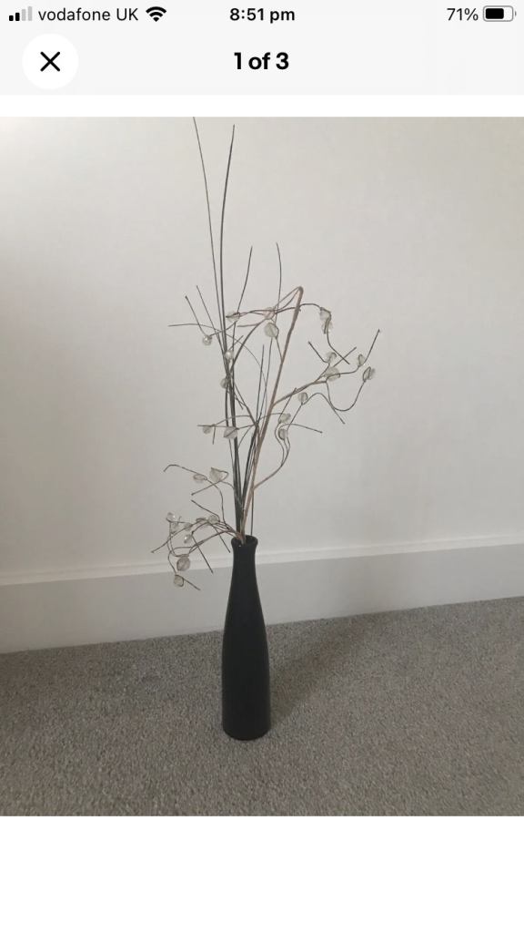 Black vase with faux twigs interior decor 