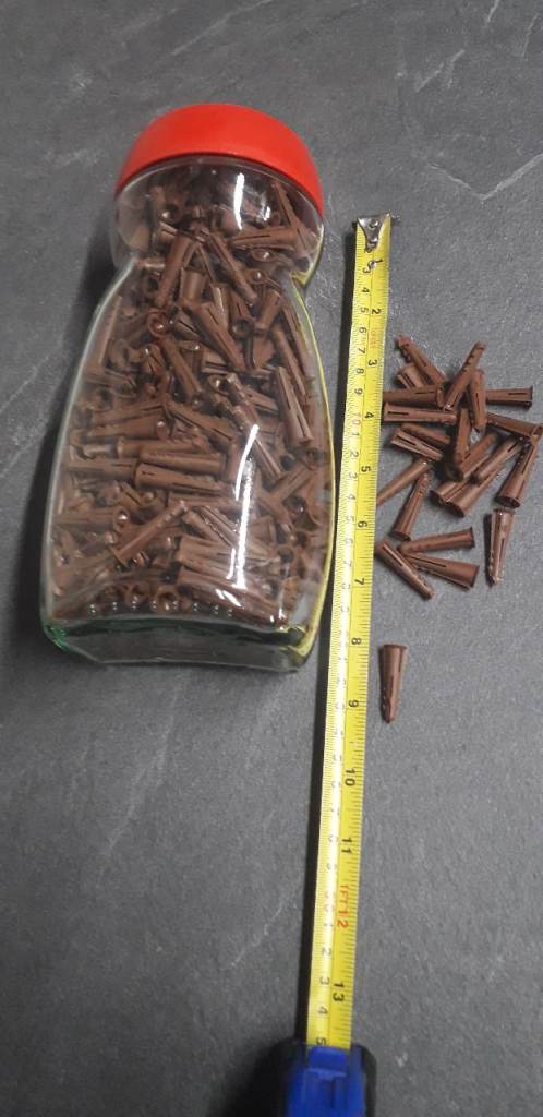 Large jar of plastic rawl plugs.