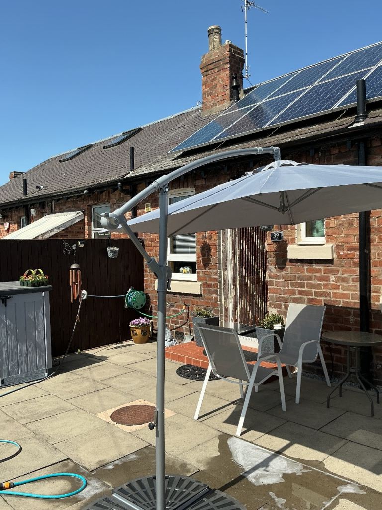 Cantilever parasol.  (Grey with base weights )