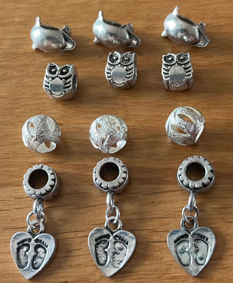 12 charms. Fit Pandora & troll bracelets. Heart feet, stardust, owls & dolphins. £3 for all 