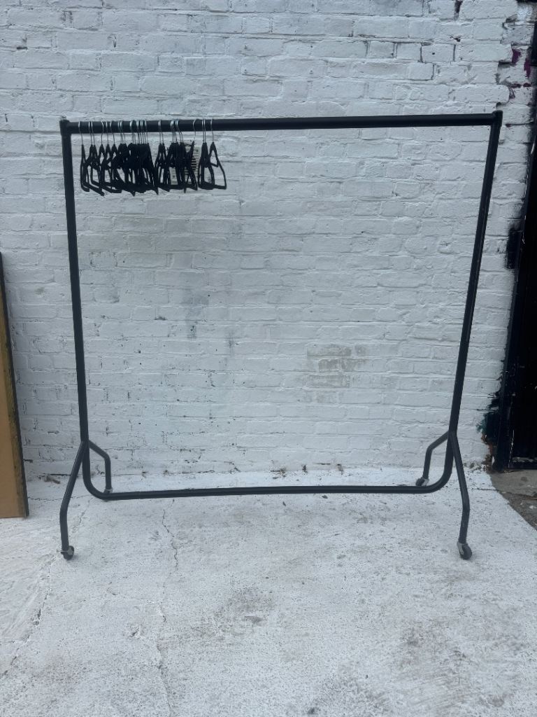 Large clothes clothing rail with hangers on wheels adjustable metal black industrial fashion studio 