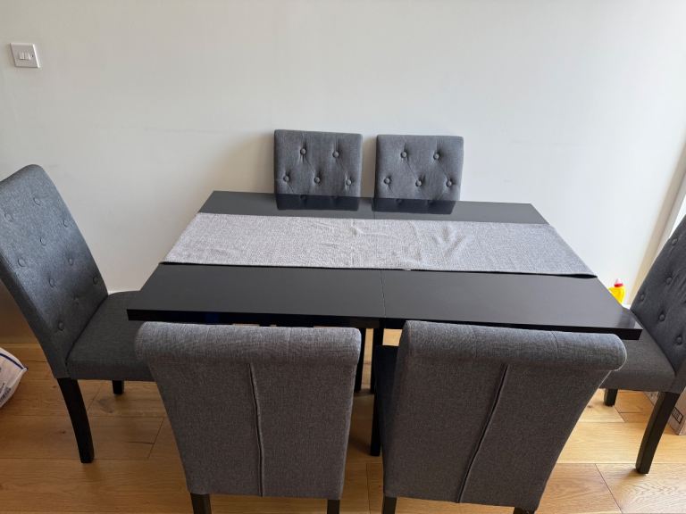 Black Dining Table with 6 Grey Upholstered Chairs – Good Condition