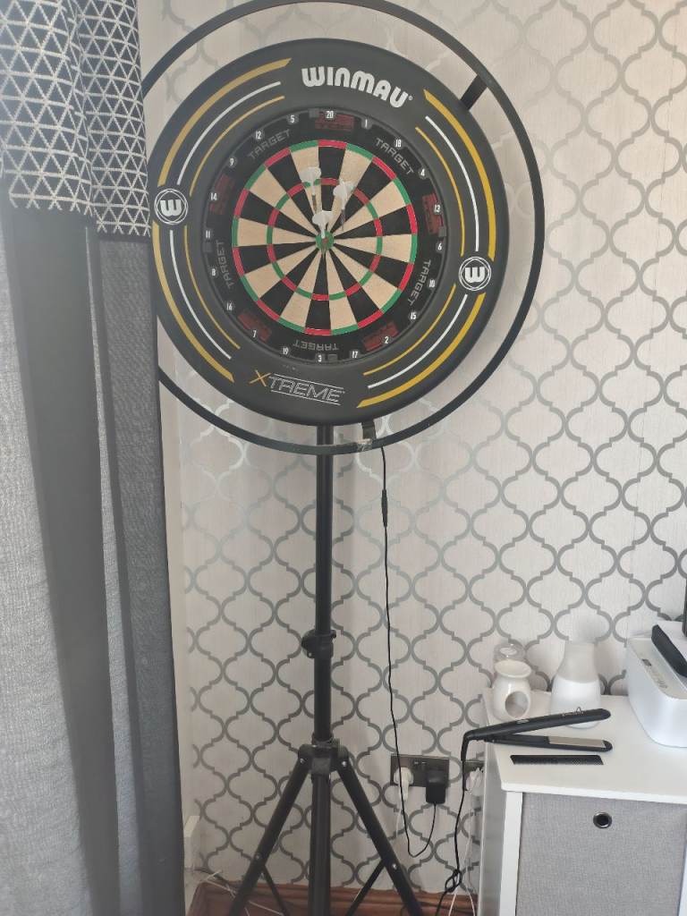 Dartboard setup with light darts surround stand