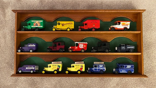 Lledo collection of 14 vintage vehicles plus display shelf.