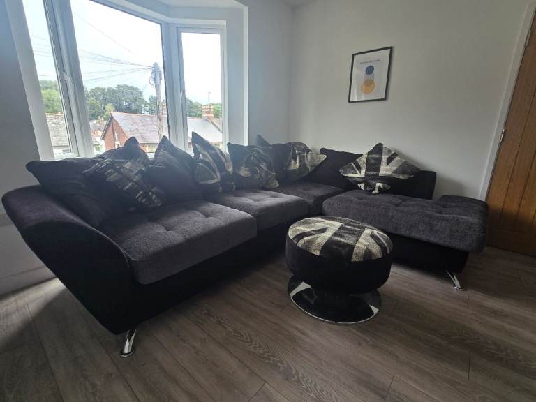 Large Black Corner Sofa with Ottoman and Cushions
