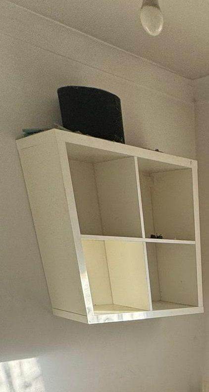 White IKEA KALLAX cube bookshelf with open compartments for storage