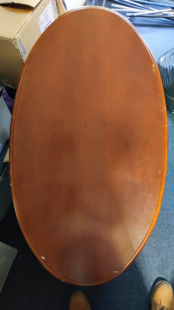 Lovely oval dark wood coffee table, with great legs. Slight damage, repairable