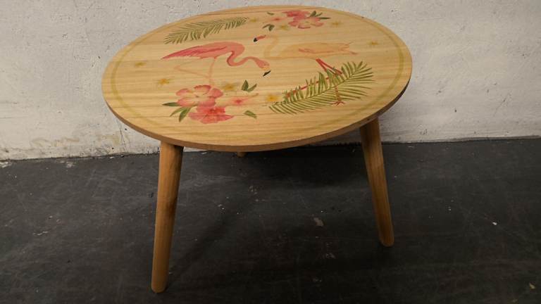 small round wood side table finished in a light wood 