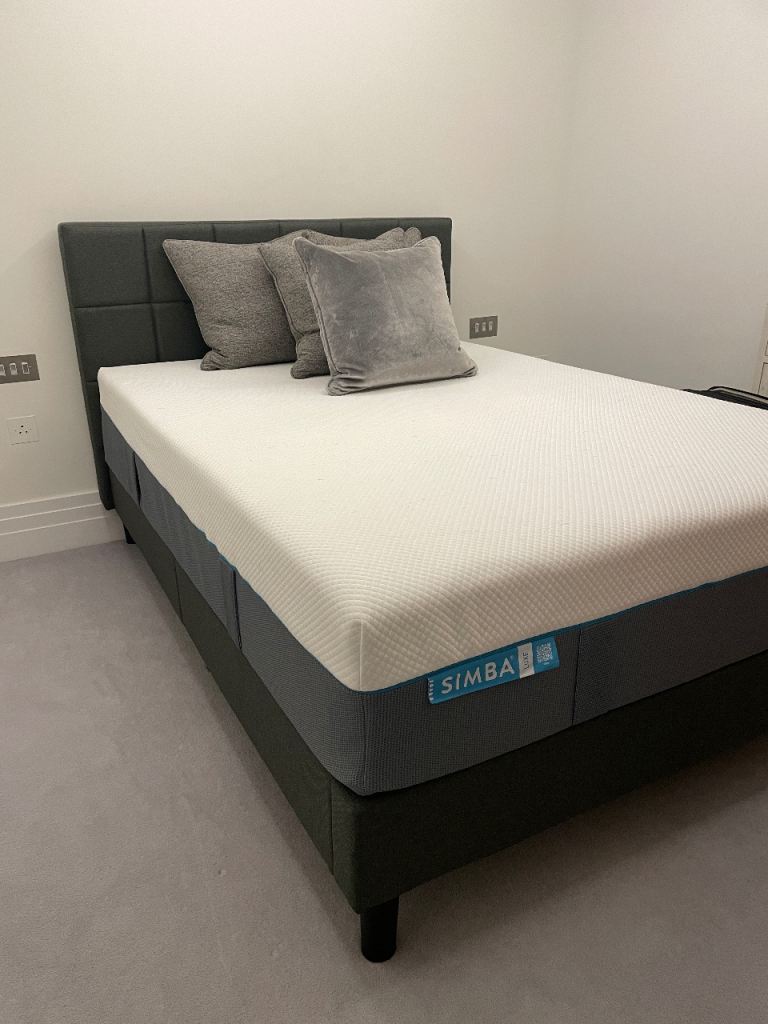 Bed, mattress & grey pillows