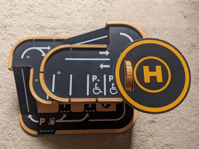 Wooden toy car park with ramps and lift to helipad