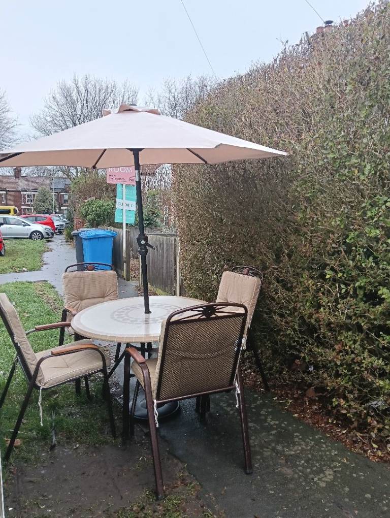 Garden table, four chairs,. parasol and stand 