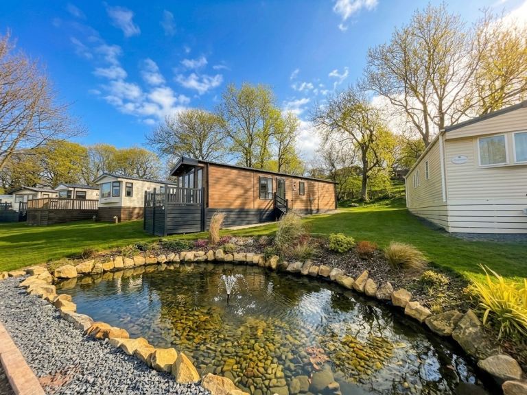 Stunning new holiday lodge for sale , 11.5 month season , site fees only £3200 including water 