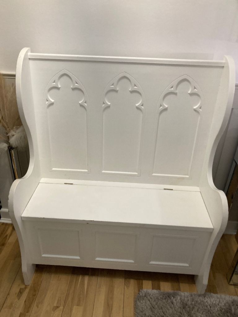 Storage pew chair as been painted white pine underneath 