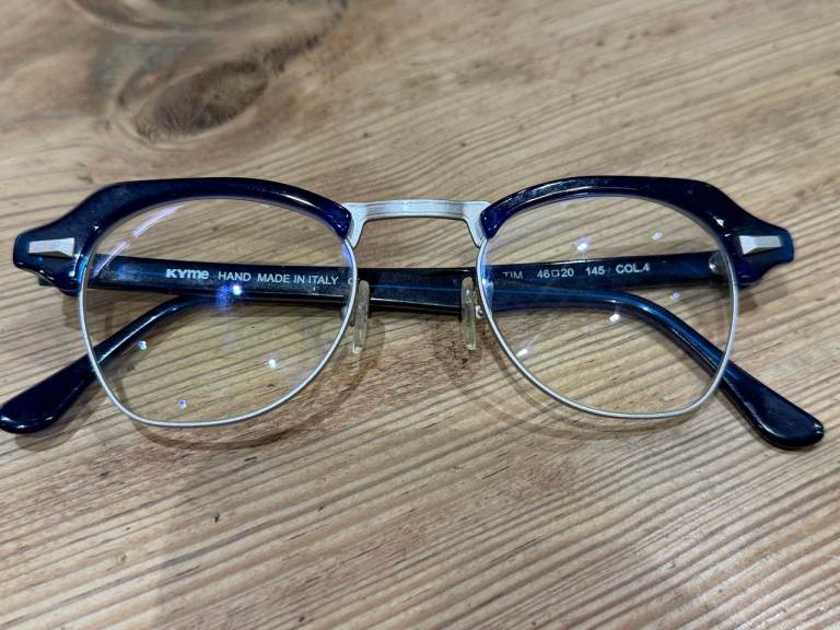 A pair of KYMIE TIM glasses frames, in a stylish blue colour.