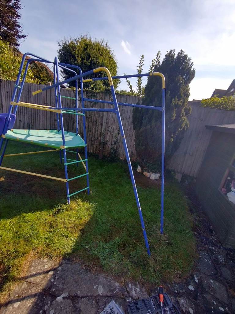 Climbing frame, monkey bars, cargo net and slide combined