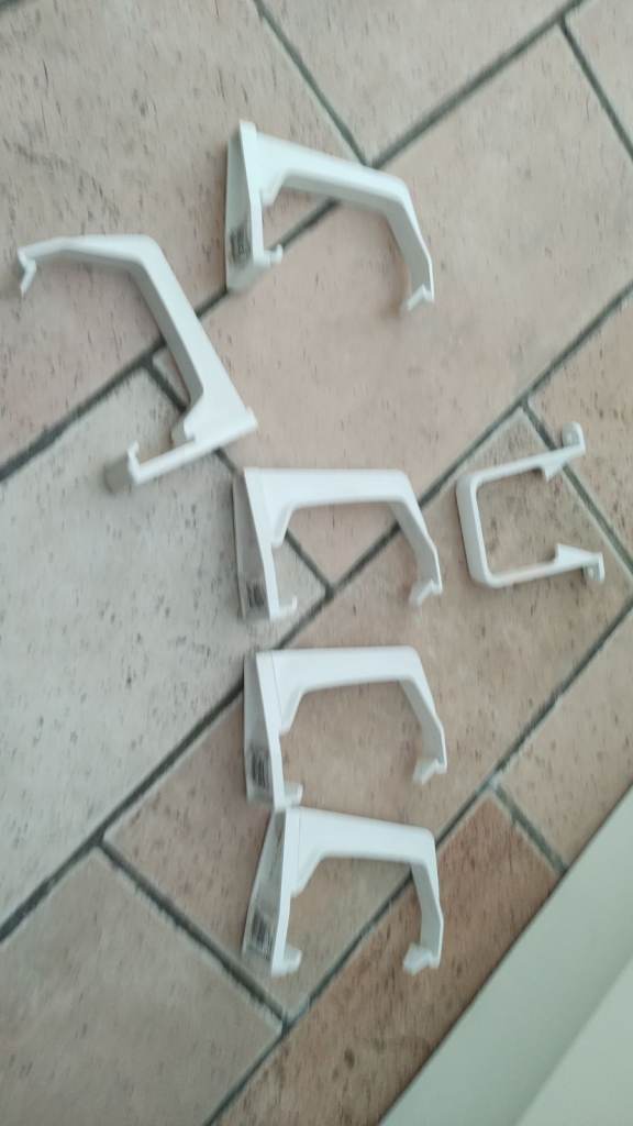 Five 114mm white square fascia brackets and one downpipe bracket