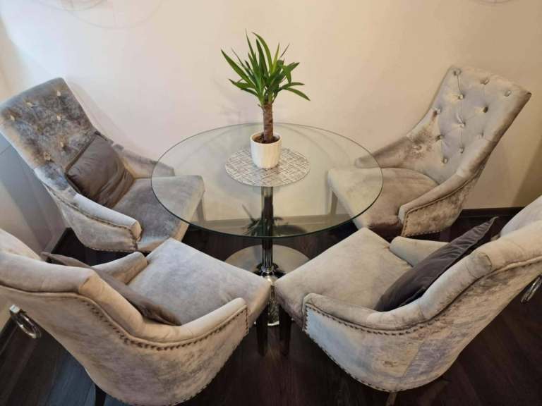 Velvet grey dining chairs and round glass table