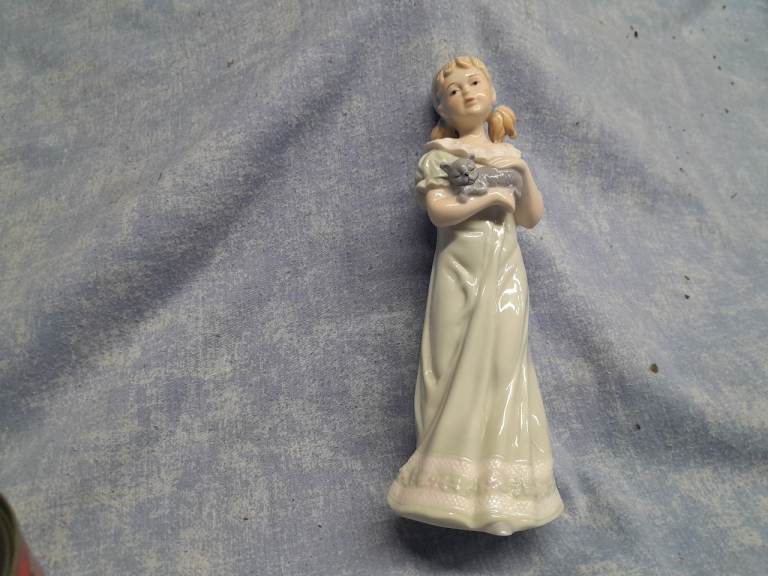 Vintage Regal collection figurine holding a cat. Bedtime range.